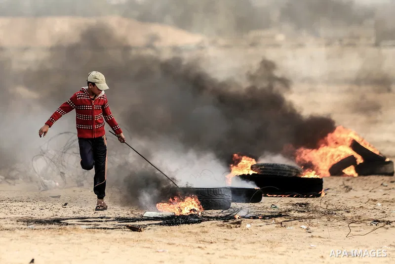 Palestinian protesters gather during clashes with Israeli troops in tents protest where Palestinians demand the right to return to their homeland at the Israel-Gaza border, in Rafah in the southern Gaza Strip on October...