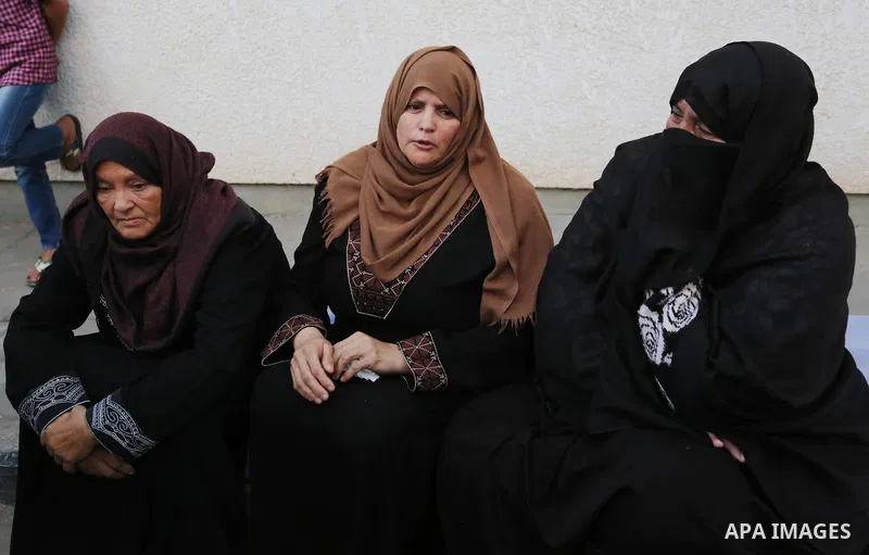 Relatives of Palestinians who were shot dead by Israeli forces during clashes with Israeli troops in tents protest where Palestinians demand the right to return to their homeland at the Israel-Gaza border, mourn in a hos...