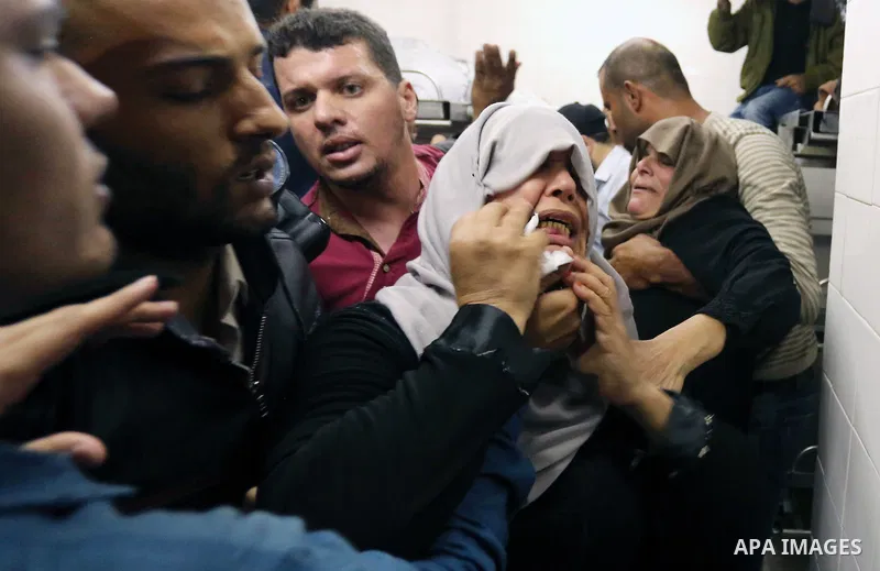 Relatives of Palestinians who were shot dead by Israeli forces during clashes with Israeli troops in tents protest where Palestinians demand the right to return to their homeland at the Israel-Gaza border, mourn in a hos...