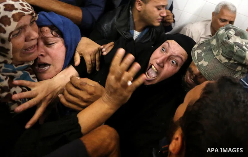 Relatives of Palestinians who were shot dead by Israeli forces during clashes with Israeli troops in tents protest where Palestinians demand the right to return to their homeland at the Israel-Gaza border, mourn in a hos...