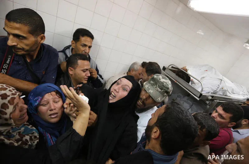 Relatives of Palestinians who were shot dead by Israeli forces during clashes with Israeli troops in tents protest where Palestinians demand the right to return to their homeland at the Israel-Gaza border, mourn in a hos...