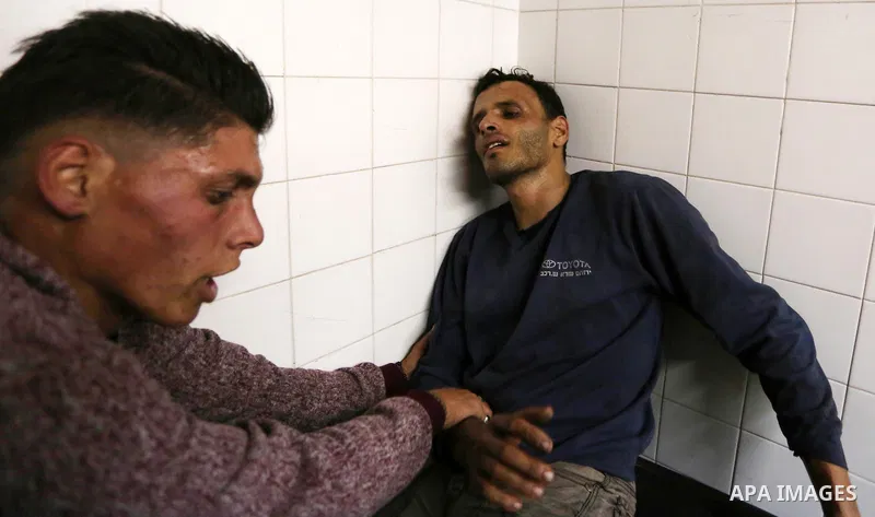 Relatives of Palestinians who were shot dead by Israeli forces during clashes with Israeli troops in tents protest where Palestinians demand the right to return to their homeland at the Israel-Gaza border, mourn in a hos...