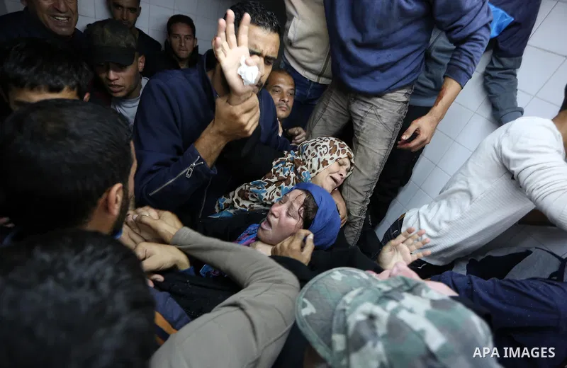 Relatives of Palestinians who were shot dead by Israeli forces during clashes with Israeli troops in tents protest where Palestinians demand the right to return to their homeland at the Israel-Gaza border, mourn in a hos...