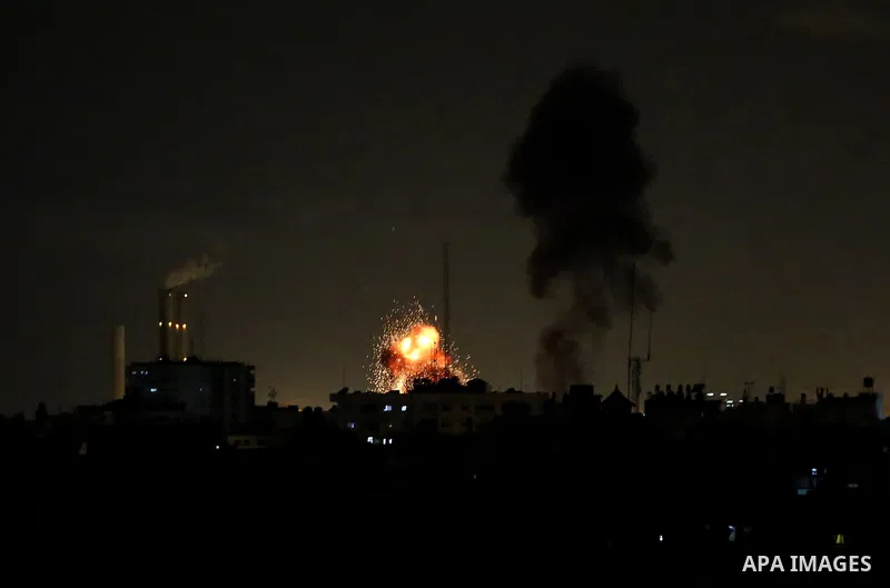 This picture taken on October 27, 2018 shows a fireball exploding during Israeli air strikes in Gaza City. A barrage of rockets from Gaza hit Israel overnight, the Israeli army said on October 27, with Israel retaliating...