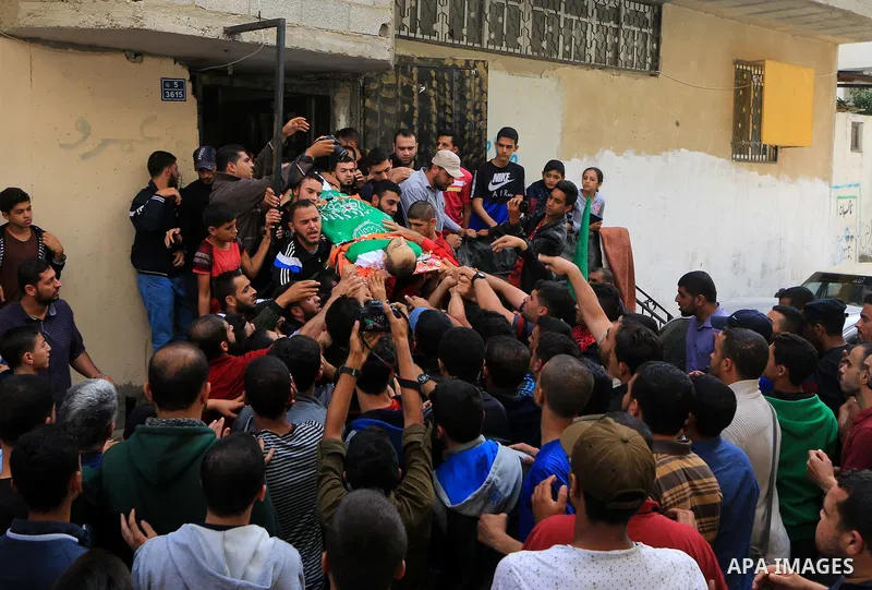 Mourners carry the body of Palestinian Mujahid Aql, 24, who was died of his wounds which he sustained by Israeli forces during clashes in tents protest where Palestinians demand the right to return to their homeland at t...