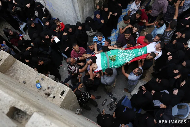 Mourners carry the body of Palestinian Ahmed Abu Lebda, 22, who was shot dead by Israeli forces during clashes in tents protest where Palestinians demand the right to return to their homeland at the Israel-Gaza border, d...