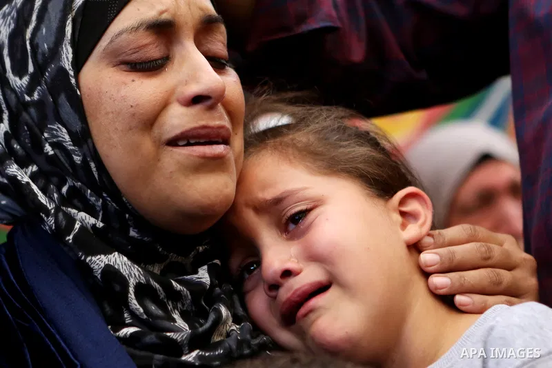 Relatives of Palestinian Othman Ladadwah, who was shot dead by Israeli forces during clashes the day before, mourn during his funeral in the village of Al-Mazraa Al-Gharbeya, in the West Bank city of Ramallah on October...
