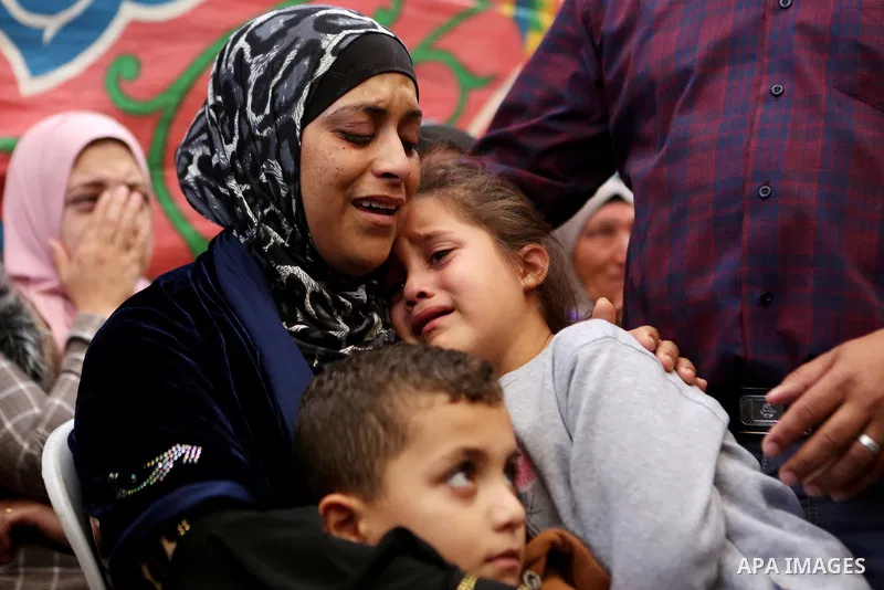 Relatives of Palestinian Othman Ladadwah, who was shot dead by Israeli forces during clashes the day before, mourn during his funeral in the village of Al-Mazraa Al-Gharbeya, in the West Bank city of Ramallah on October...