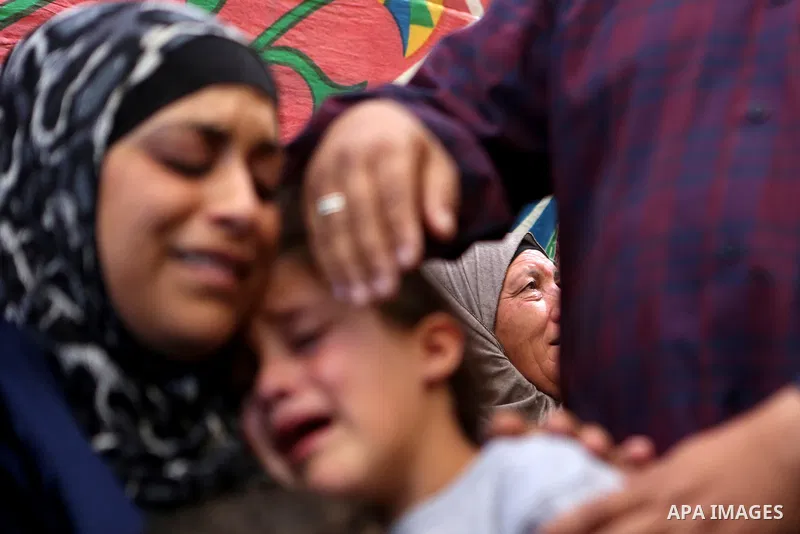 Relatives of Palestinian Othman Ladadwah, who was shot dead by Israeli forces during clashes the day before, mourn during his funeral in the village of Al-Mazraa Al-Gharbeya, in the West Bank city of Ramallah on October...
