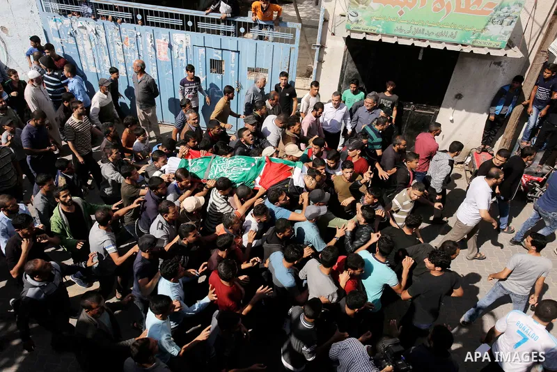 Mourners carry the body of Palestinian Ahmed Abu Lebda, 22, who was shot dead by Israeli forces during clashes in tents protest where Palestinians demand the right to return to their homeland at the Israel-Gaza border, d...