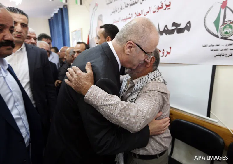 Palestinian Prime Minister Rami Hamdallah offers condolences for the family of Mohammed Basharat, who was shot dead by Israeli forces last Wednesday, in the village of Taamun near the West Bank city of Tubas, on October...