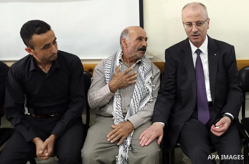 Palestinian Prime Minister Rami Hamdallah offers condolences for the family of Mohammed Basharat, who was shot dead by Israeli forces last Wednesday, in the village of Taamun near the West Bank city of Tubas, on October...