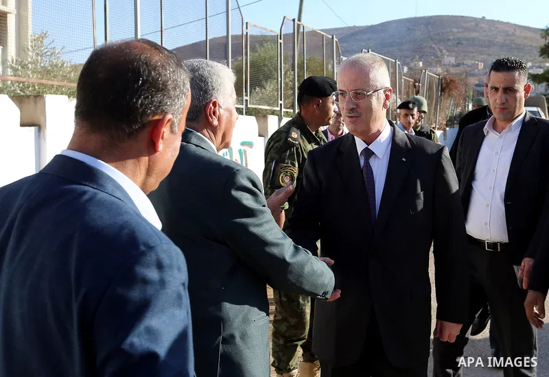 Palestinian Prime Minister Rami Hamdallah offers condolences for the family of Mohammed Basharat, who was shot dead by Israeli forces last Wednesday, in the village of Taamun near the West Bank city of Tubas, on October...