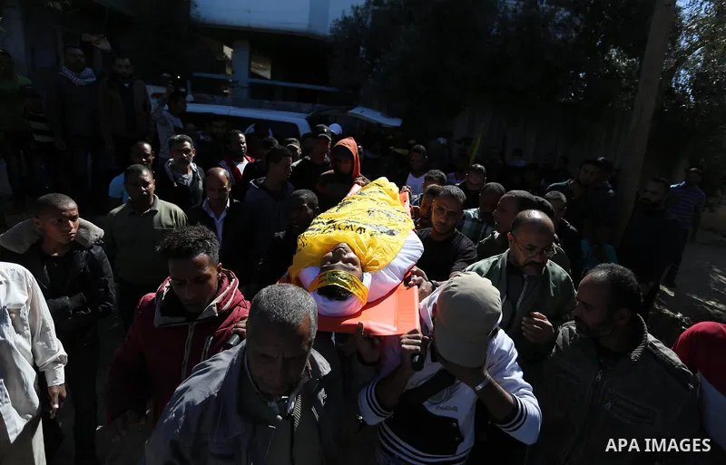 Mourners carry the body of Palestinian Yahya el-Hassanat, 37, who was shot dead by Israeli troops during clashes in tents protest where Palestinian demand rights to return to their homeland at Israel-Gaza border, during...