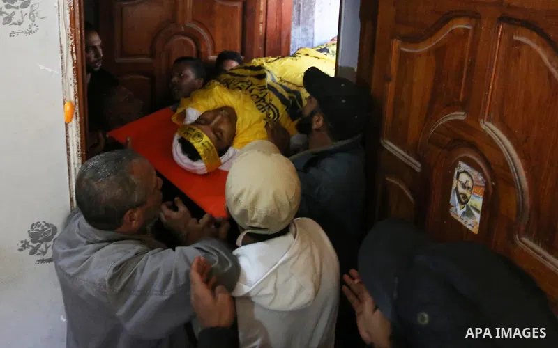 Mourners carry the body of Palestinian Yahya el-Hassanat, 37, who was shot dead by Israeli troops during clashes in tents protest where Palestinian demand rights to return to their homeland at Israel-Gaza border, during...