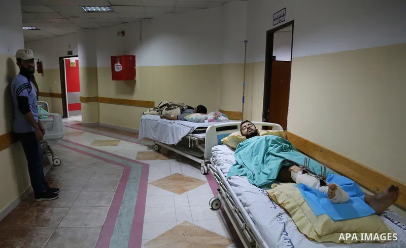 The picture taken on October 27, 2018 shows Palestinian patients lie on the beds in a corridor at Indonesia hospital after an Israeli air strike in northern of Gaza Strip. A barrage of rockets from Gaza hit Israel overni...