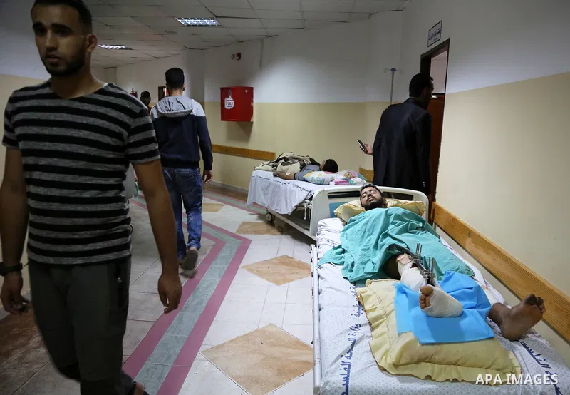 The picture taken on October 27, 2018 shows Palestinian patients lie on the beds in a corridor at Indonesia hospital after an Israeli air strike in northern of Gaza Strip. A barrage of rockets from Gaza hit Israel overni...