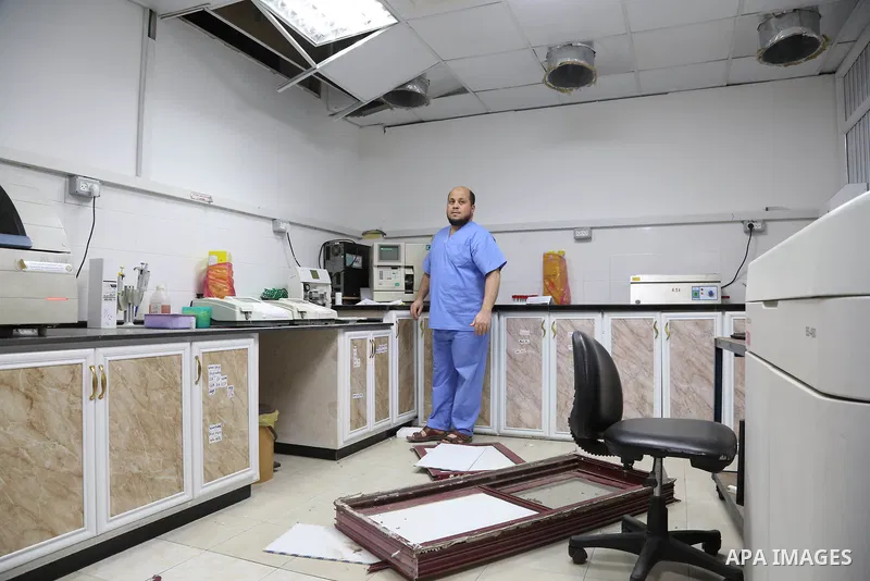 The picture taken on October 27, 2018 shows A Palestinian inspects the damaged of Indonesia hospital after an Israeli air strike in northern of Gaza Strip. A barrage of rockets from Gaza hit Israel overnight, the Israeli...