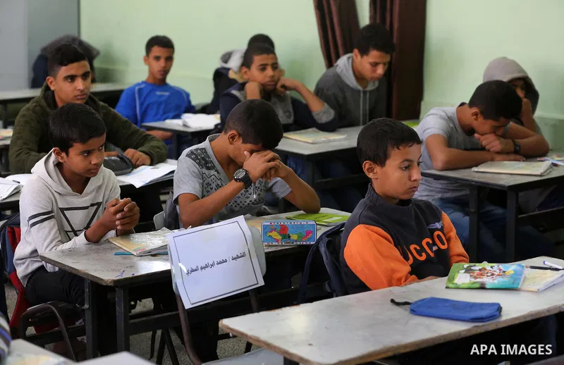 Classmates of Palestinian's boy Mohammed al-Sattari, who was killed in an Israeli air strike on the Gaza Strip, react at a school, in Deir al-Balah in the central Gaza Strip, on October 29, 2018. Photo by Ashraf Amra