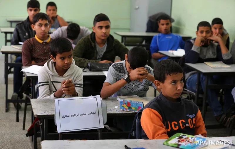 Classmates of Palestinian's boy Mohammed al-Sattari, who was killed in an Israeli air strike on the Gaza Strip, react at a school, in Deir al-Balah in the central Gaza Strip, on October 29, 2018. Photo by Ashraf Amra