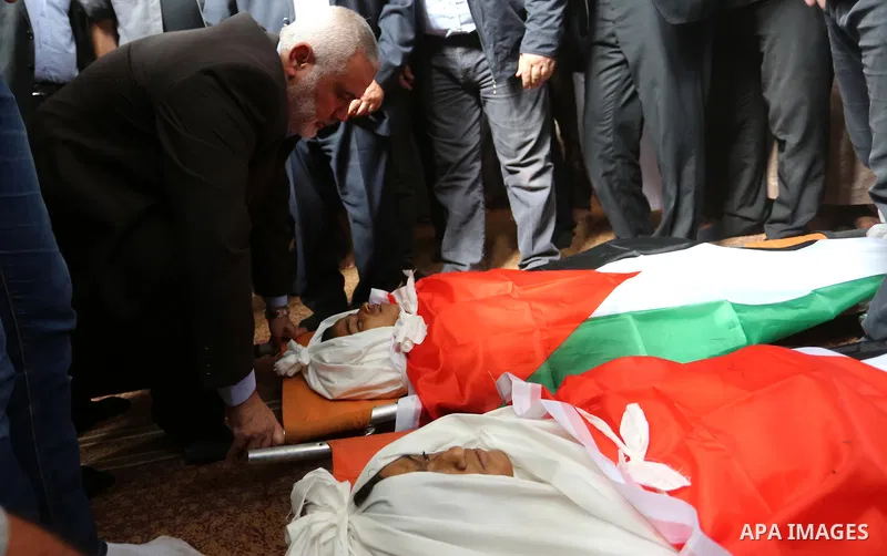Palestinian Hamas Chief Ismail Haniyeh attends the funeral of three Palestinian teenagers who were killed in an Israeli air strike on the Gaza Strip during their funeral in Deir el-Balah in central of the Gaza Strip on O...