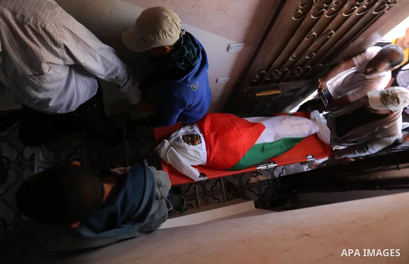 Mourners carry the body of Palestinian teenager Khaled Saed, who was killed in an Israeli air strike on the Gaza Strip , during his funeral in Deir el-Balah in central of the Gaza Strip on October 29, 2018. Photo by Ashr...