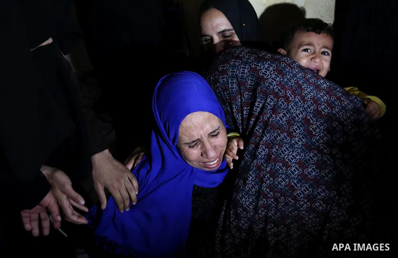 Relatives of Palestinian teenager Khaled Saed, who was killed in an Israeli air strike on the Gaza Strip , mourn during his funeral in Deir el-Balah in central of the Gaza Strip on October 29, 2018. Photo by Ashraf Amra
