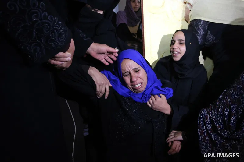 Relatives of Palestinian teenager Khaled Saed, who was killed in an Israeli air strike on the Gaza Strip , mourn during his funeral in Deir el-Balah in central of the Gaza Strip on October 29, 2018. Photo by Ashraf Amra