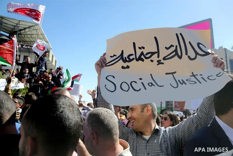 Palestinians take part during a protest against a social security law, in the West Bank city of Ramallah on October 29, 2018. Photo by Shadi Hatem