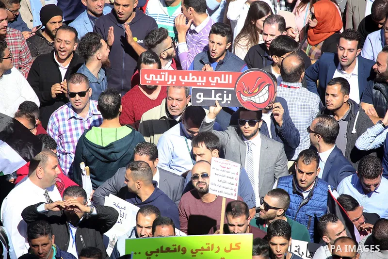 Palestinians take part during a protest against a social security law, in the West Bank city of Ramallah on October 29, 2018. Photo by Shadi Hatem