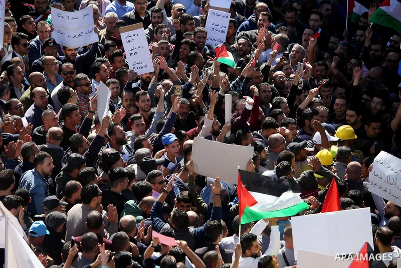 Palestinians take part during a protest against a social security law, in the West Bank city of Ramallah on October 29, 2018. Photo by Shadi Hatem