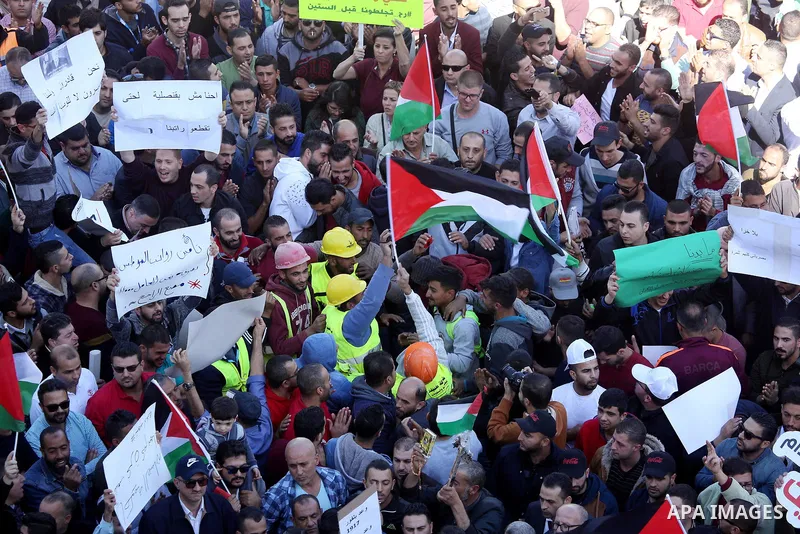 Palestinians take part during a protest against a social security law, in the West Bank city of Ramallah on October 29, 2018. Photo by Shadi Hatem
