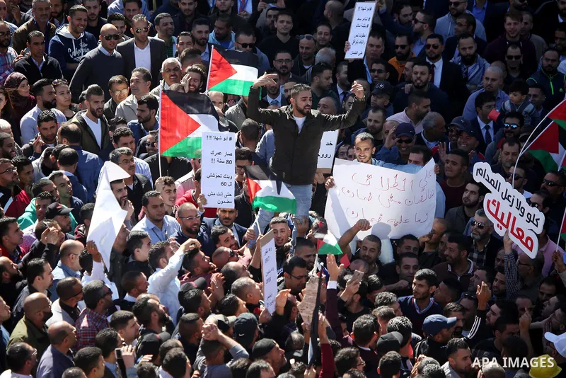 Palestinians take part during a protest against a social security law, in the West Bank city of Ramallah on October 29, 2018. Photo by Shadi Hatem