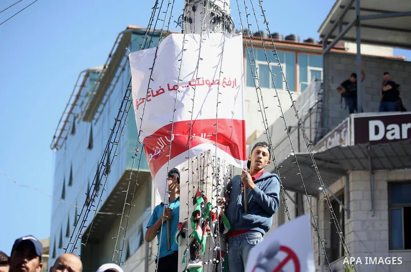 Palestinians take part during a protest against a social security law, in the West Bank city of Ramallah on October 29, 2018. Photo by Shadi Hatem