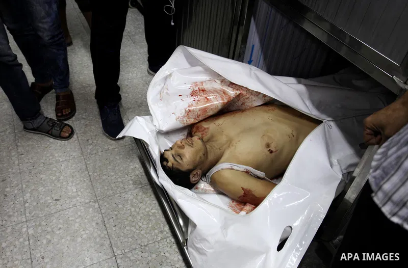 Relatives of Palestinian Mohammed abu Abada, 27, who was shot dead by Israeli forces during clashes along the Gaza sea barrier on the maritime border with Israel, in the northern Gaza Strip, mourn over his body at morgue...