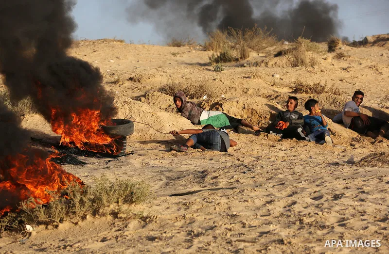 Palestinian protesters gather during clashes with Israeli forces in a demonstration against the Israeli blockade on Gaza Strip, along the Gaza sea barrier on the maritime border with Israel near Kibbutz Zikim, north of B...