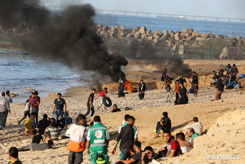 Palestinian protesters gather during clashes with Israeli forces in a demonstration against the Israeli blockade on Gaza Strip, along the Gaza sea barrier on the maritime border with Israel near Kibbutz Zikim, north of B...