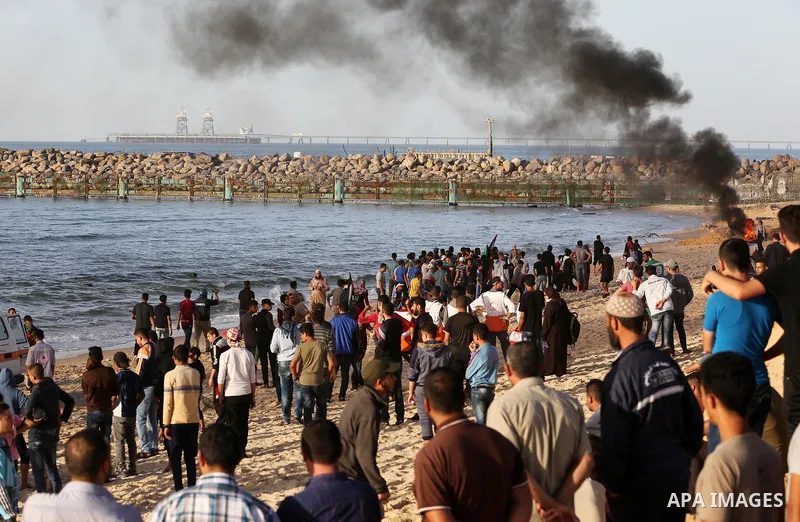 Palestinian protesters gather during clashes with Israeli forces in a demonstration against the Israeli blockade on Gaza Strip, along the Gaza sea barrier on the maritime border with Israel near Kibbutz Zikim, north of B...