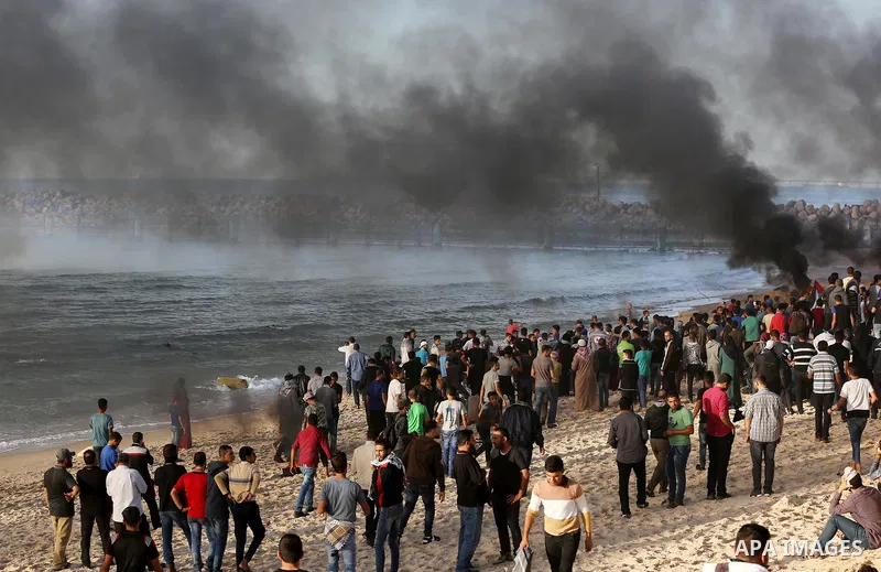 Palestinian protesters gather during clashes with Israeli forces in a demonstration against the Israeli blockade on Gaza Strip, along the Gaza sea barrier on the maritime border with Israel near Kibbutz Zikim, north of B...