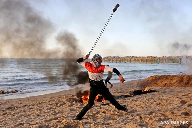 Palestinian protesters gather during clashes with Israeli forces in a demonstration against the Israeli blockade on Gaza Strip, along the Gaza sea barrier on the maritime border with Israel near Kibbutz Zikim, north of B...