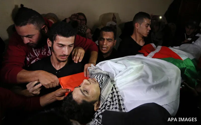Mourners carry the body of Palestinian Mohammed abu Abada, 27, who was shot dead by Israeli forces during a demonstration against the Israeli blockade on Gaza Strip, along the Gaza sea barrier on the maritime border with...