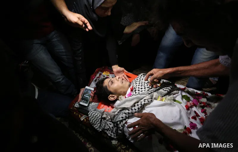 Relatives of Palestinian Mohammed abu Abada, 27, who was shot dead by Israeli forces during a demonstration against the Israeli blockade on Gaza Strip, along the Gaza sea barrier on the maritime border with Israel near K...
