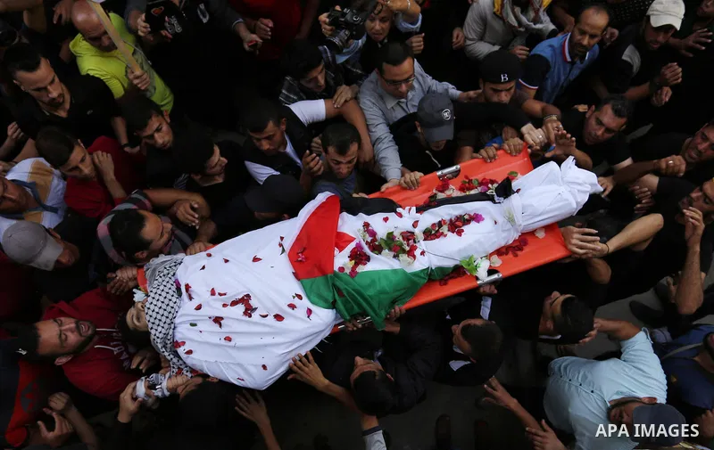Mourners carry the body of Palestinian Mohammed abu Abada, 27, who was shot dead by Israeli forces during a demonstration against the Israeli blockade on Gaza Strip, along the Gaza sea barrier on the maritime border with...