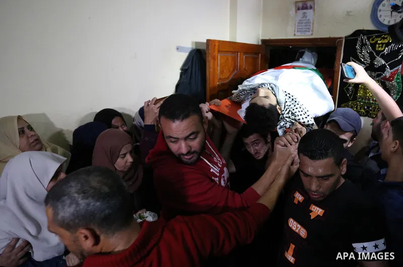 Mourners carry the body of Palestinian Mohammed abu Abada, 27, who was shot dead by Israeli forces during a demonstration against the Israeli blockade on Gaza Strip, along the Gaza sea barrier on the maritime border with...