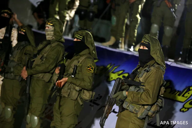 Palestinian Islamic Jihad militants take part during a memorial service for Islamic Jihad militants who were killed in an Israeli operation to blow up a tunnel last year, at the Bureij refugee camp, in central Gaza Strip...