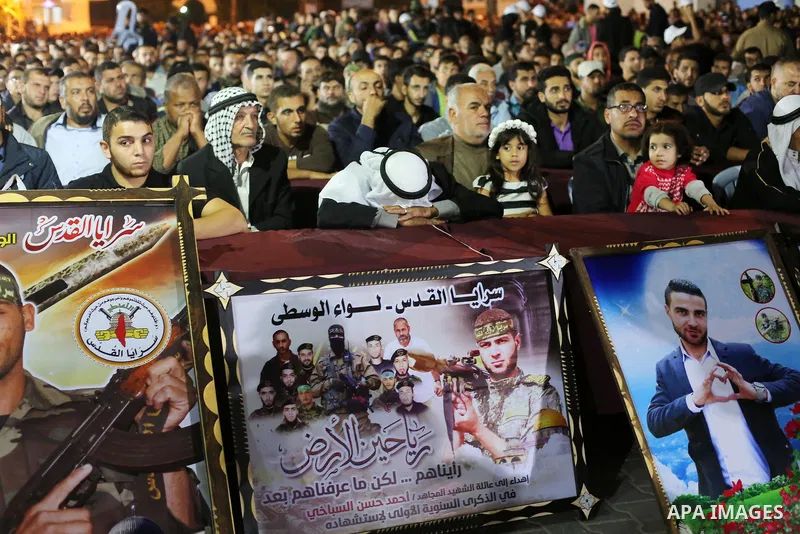 Palestinian supporters of Islamic Jihad movement attends a memorial service for Islamic Jihad militants who were killed in an Israeli operation to blow up a tunnel last year, at the Bureij refugee camp, in central Gaza S...