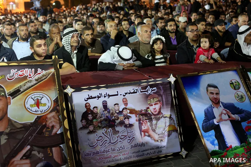 Palestinian supporters of Islamic Jihad movement attends a memorial service for Islamic Jihad militants who were killed in an Israeli operation to blow up a tunnel last year, at the Bureij refugee camp, in central Gaza S...