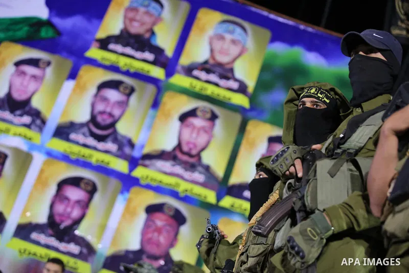 Palestinian Islamic Jihad militants take part during a memorial service for Islamic Jihad militants who were killed in an Israeli operation to blow up a tunnel last year, at the Bureij refugee camp, in central Gaza Strip...