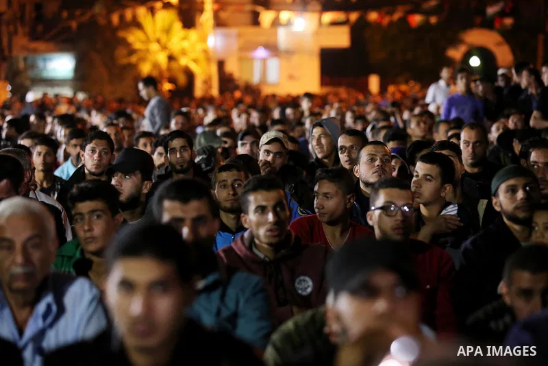 Palestinian supporters of Islamic Jihad movement attends a memorial service for Islamic Jihad militants who were killed in an Israeli operation to blow up a tunnel last year, at the Bureij refugee camp, in central Gaza S...