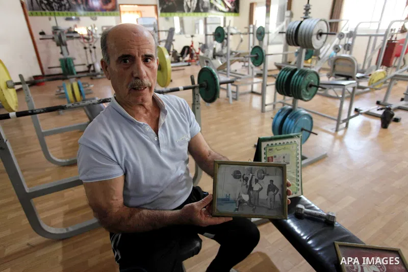 Palestinian weightlifting's coach Ali al-Nono, 74, displays his photos at a club in Gaza City on November 3, 2018. Al-Nono playing weightlifting for more than 50 years and won in prizes in local and Arab competitions. Ph...